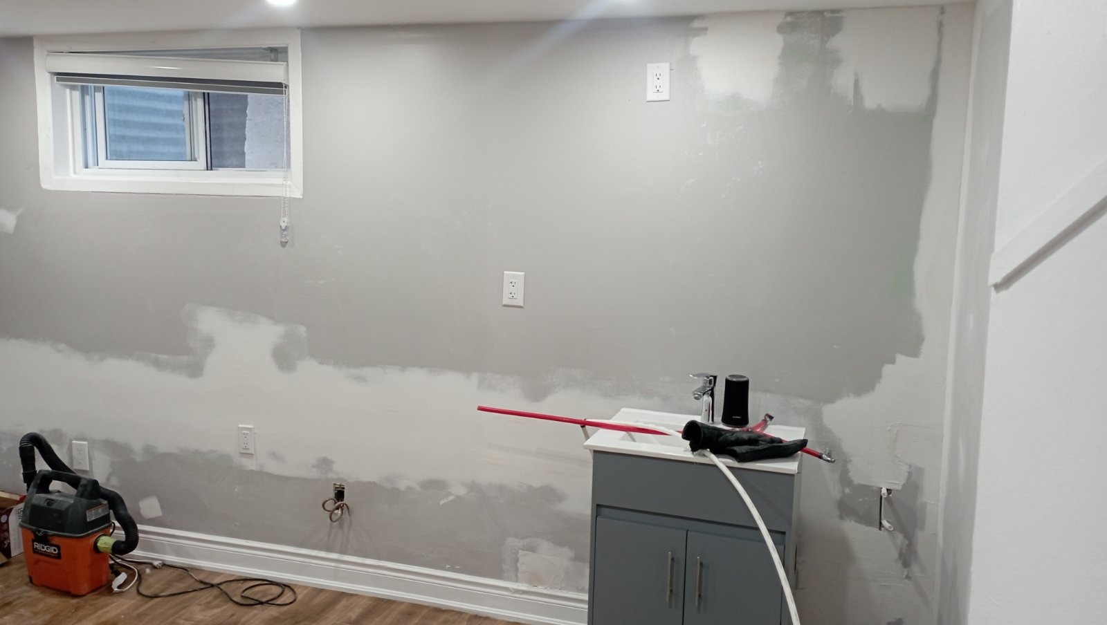 Basement wall drywall mud applied around outlets and seams